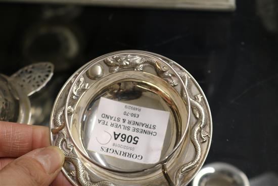 A late 19th/early 20th century Chinese Export silver tea strainer and stand by Wang Hing, Hong Kong, height 44mm.